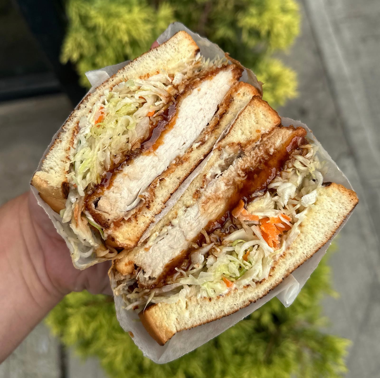 Chicken Katsu on milk bread, cut to show the cutlet and slaw